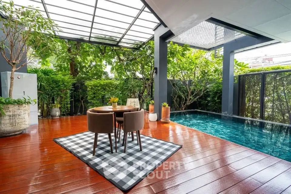 Luxurious outdoor patio with private pool and lush greenery, perfect for relaxation and entertainment.