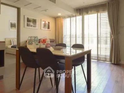 Spacious dining area with natural light and modern decor in a stylish apartment.