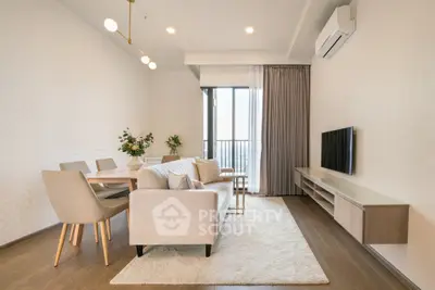 Elegant living room with modern furniture and large window offering natural light and city view.