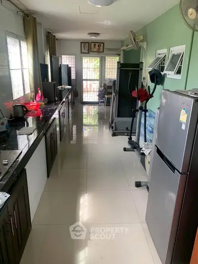 Spacious kitchen with modern appliances and ample natural light, perfect for culinary enthusiasts.