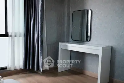 Modern minimalist bedroom corner with sleek mirror and elegant curtains.