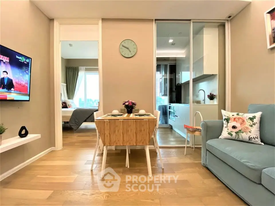 Modern open-plan living room with cozy seating and stylish kitchen