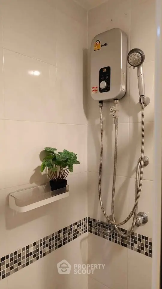 Modern bathroom with sleek shower unit and stylish tile accents