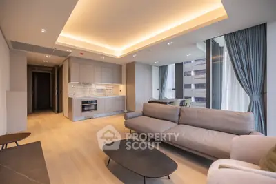 Luxurious modern living room with open kitchen and elegant furnishings in a high-rise apartment.
