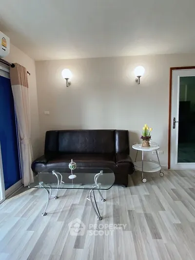 Modern living room with sleek leather sofa and glass coffee table