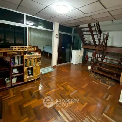 Spacious living room with wooden flooring and staircase in a cozy home