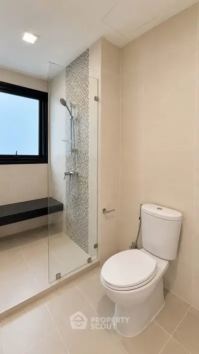 Modern bathroom with sleek shower and elegant fixtures in a contemporary home.
