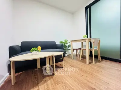 Modern minimalist living room with wooden flooring and stylish furniture