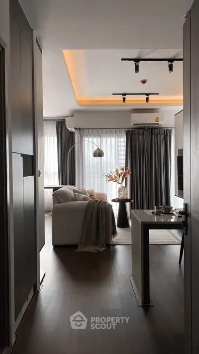 Modern living room with elegant decor and large windows in a stylish apartment.