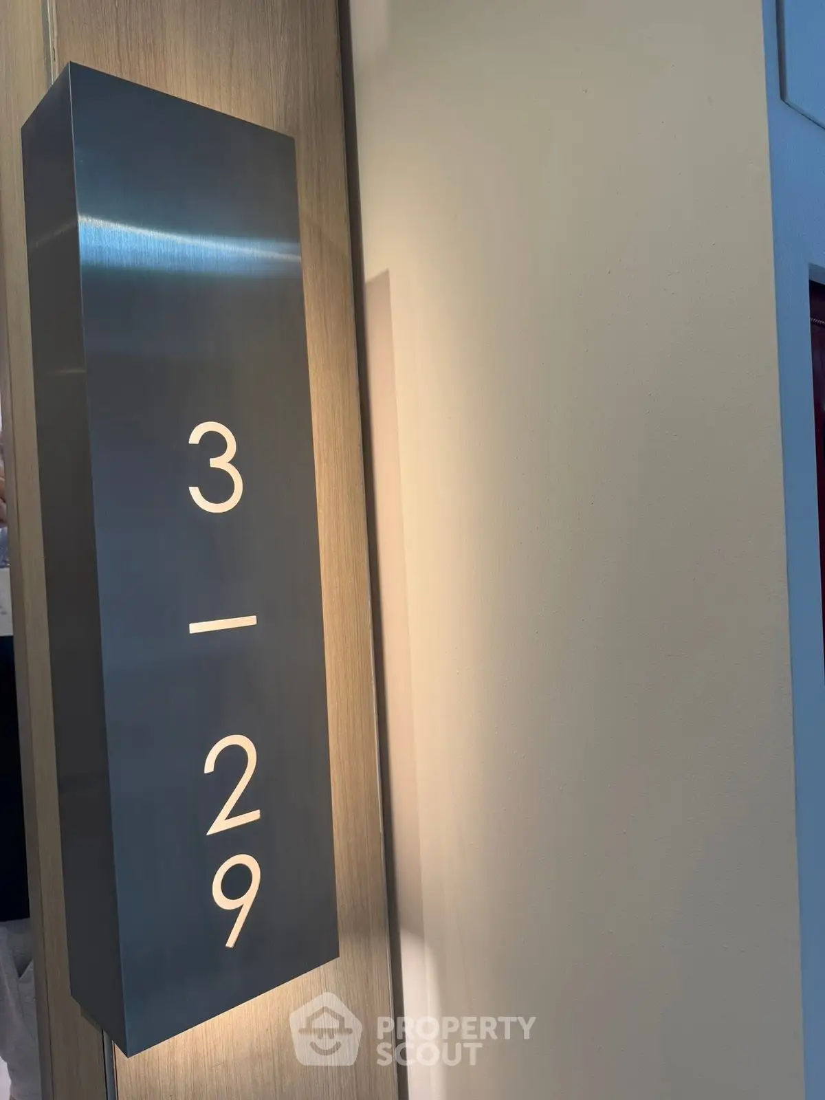 Modern building floor number sign with sleek design and ambient lighting