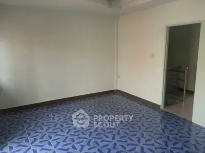 Spacious room with unique blue patterned tile flooring in modern home