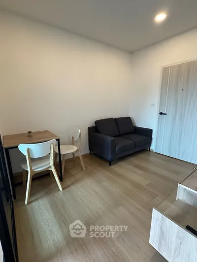 Cozy modern living room with wooden flooring and compact dining area