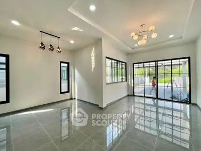 Spacious modern living room with elegant lighting and large windows