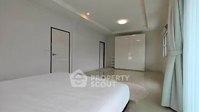 Spacious bedroom with modern wardrobe and natural light