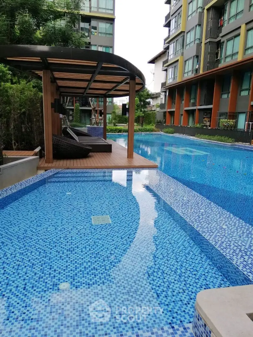 Luxurious apartment complex with stunning poolside cabana and modern architecture.