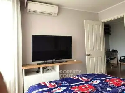Cozy bedroom with modern air conditioning and flat-screen TV, perfect for relaxation.