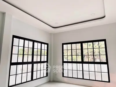Bright and spacious room with large windows and modern ceiling design, perfect for natural light lovers.