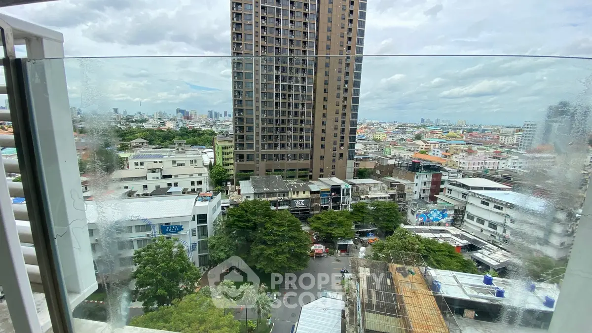 Stunning cityscape view from a high-rise balcony with expansive skyline and urban landscape.