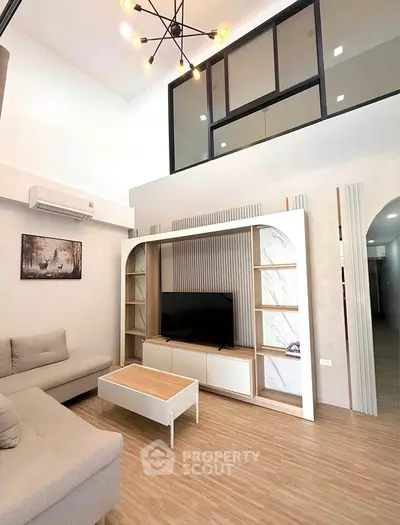 Modern living room with high ceiling and stylish furniture in a contemporary apartment.