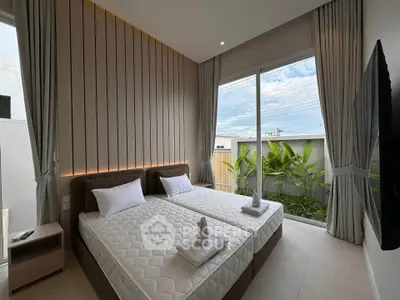 Luxurious bedroom with twin beds, large window, and garden view in modern home.