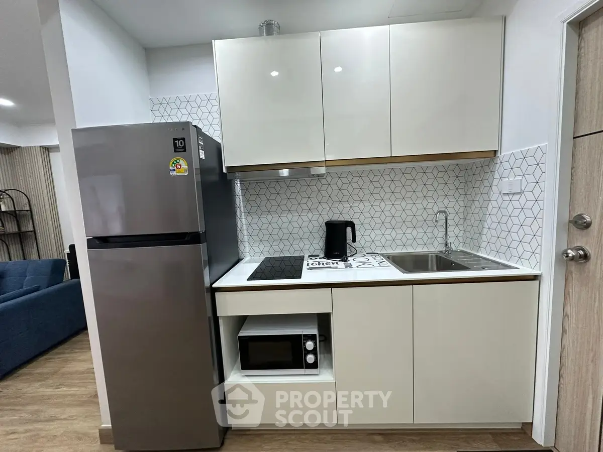 Modern compact kitchen with sleek appliances and stylish cabinetry