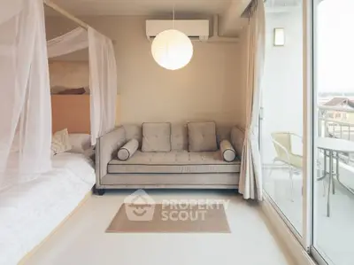 Chic modern bedroom with cozy sofa and balcony access, perfect for relaxation and enjoying the view.