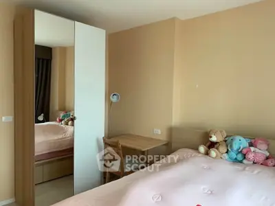 Cozy bedroom with plush toys and a study corner, perfect for relaxation and work.