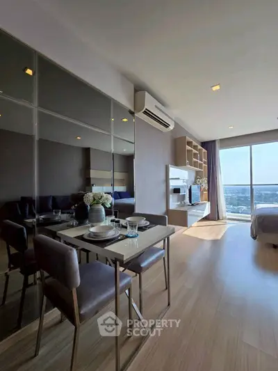 Modern open-plan living room with dining area and large windows offering stunning city views.