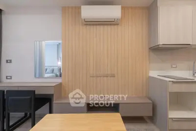 Modern minimalist living space with sleek furniture and air conditioning unit, perfect for urban living.