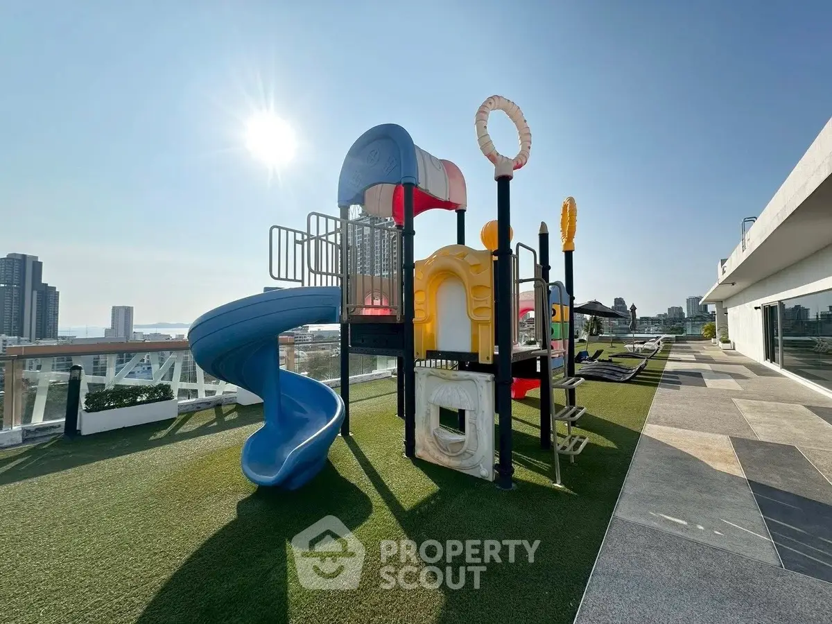 Stunning rooftop playground with city views, perfect for family-friendly living in urban high-rise.