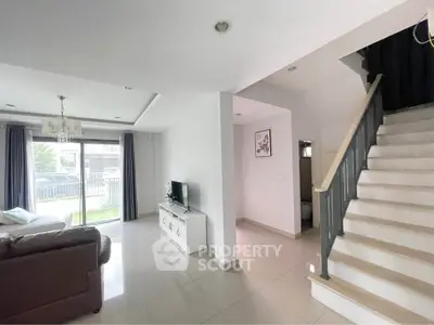 Spacious living room with modern decor and staircase in a bright home