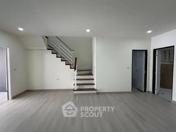 Spacious modern living room with sleek staircase and minimalist design