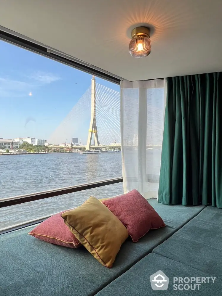 Stunning river view from modern living room with cozy seating and large windows