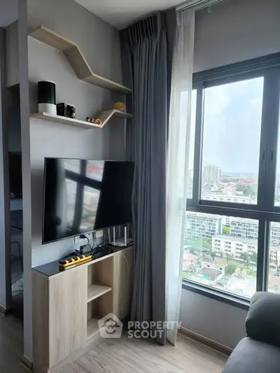 Modern living room with large window and stylish TV setup offering city views.
