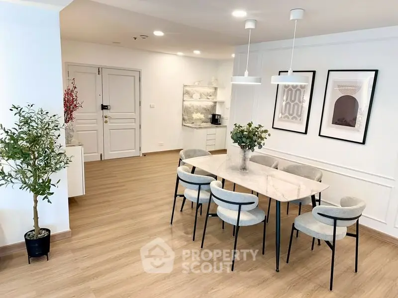 Elegant dining area with modern decor and stylish lighting in a spacious apartment.