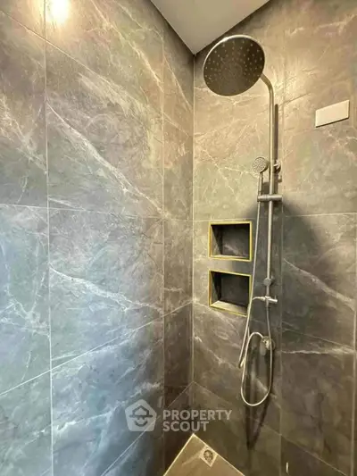 Modern bathroom with sleek shower and marble tiles