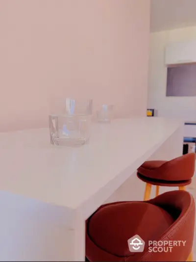 Modern kitchen with sleek white countertop and stylish bar stools