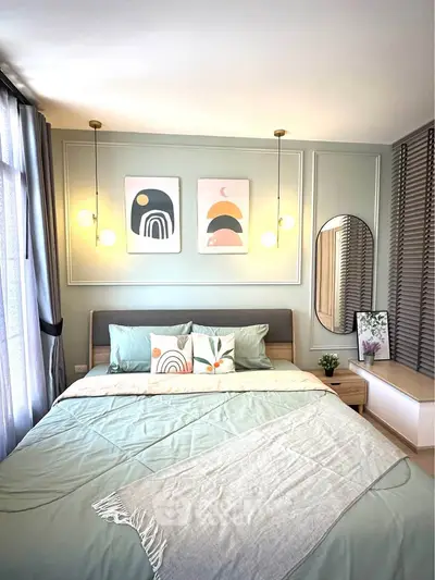 Stylish bedroom with modern decor and cozy bedding in a well-lit space.