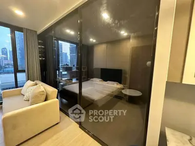 Modern apartment with glass-walled bedroom and city view, featuring cozy living area and stylish decor.