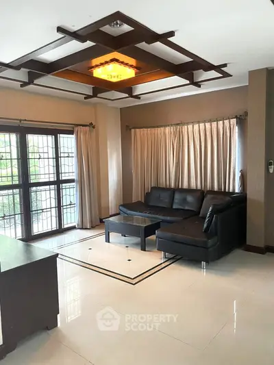 Elegant living room with modern leather sofa and stylish ceiling design