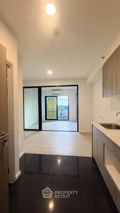 Modern apartment interior with open layout and balcony view