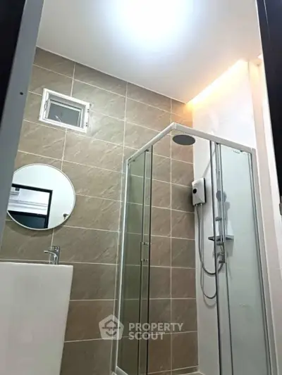 Modern bathroom with glass shower and stylish tile design