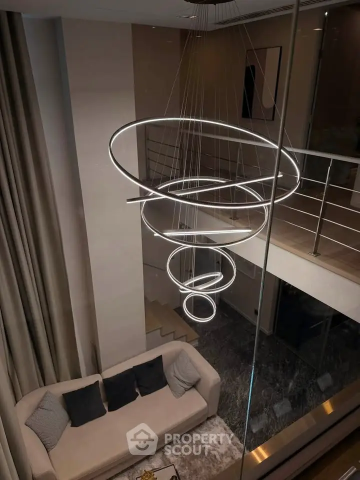 Luxurious modern living room with unique spiral chandelier and elegant decor