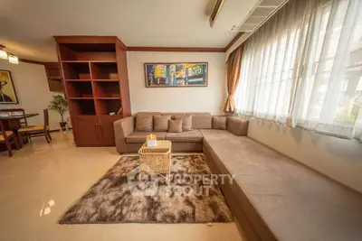 Spacious living room with cozy sectional sofa and large window for natural light.