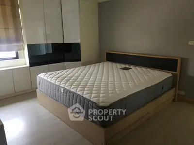 Spacious bedroom with modern design and large bed, perfect for comfort and relaxation.