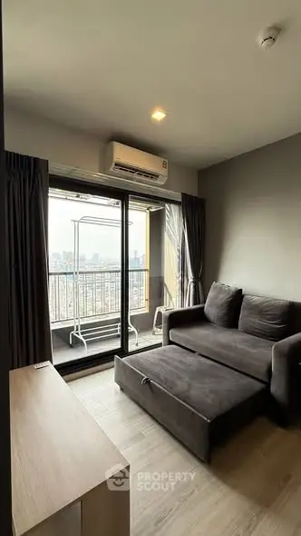 Modern living room with balcony view in high-rise apartment