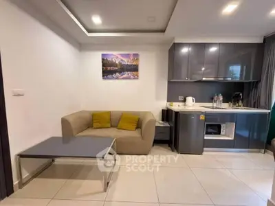 Modern living room with sleek kitchenette, cozy sofa, and stylish decor in a contemporary apartment.