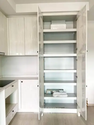 Modern kitchen with sleek white cabinetry and ample storage space