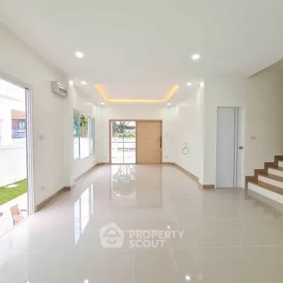 Spacious modern living room with glossy tiles and recessed lighting