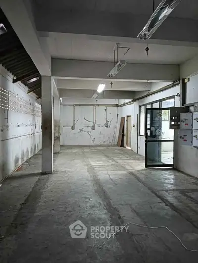 Spacious industrial warehouse with high ceilings and ample natural light.